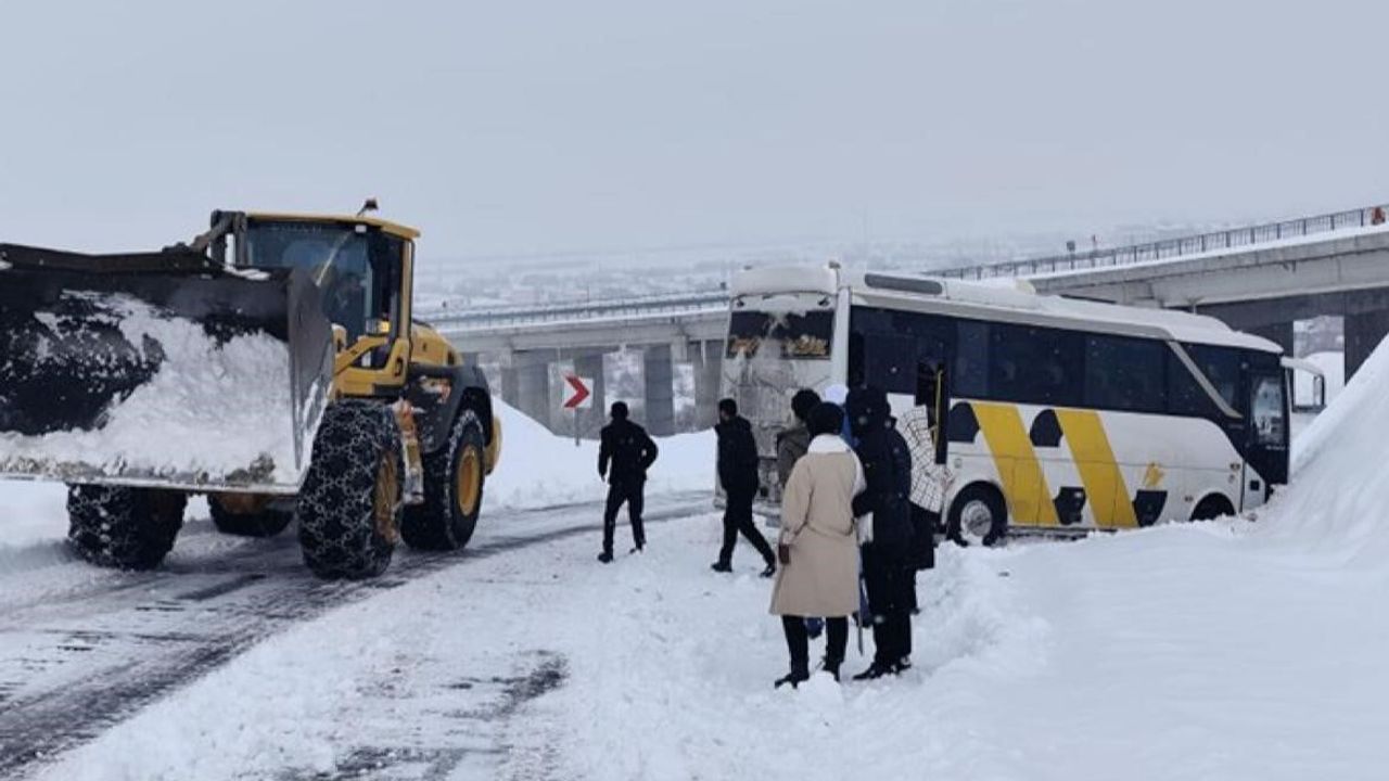 Genç'te karla kaplı yolda midibüs kara saplandı