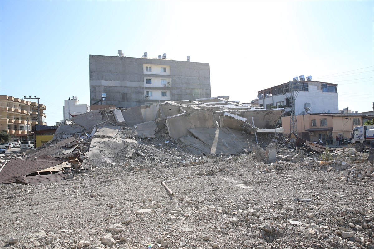 Hatay'ın Arsuz ilçesinde, ağır hasarlı bir binanın yıkımı sırasında iş makinesinin üzerine çökmesi...