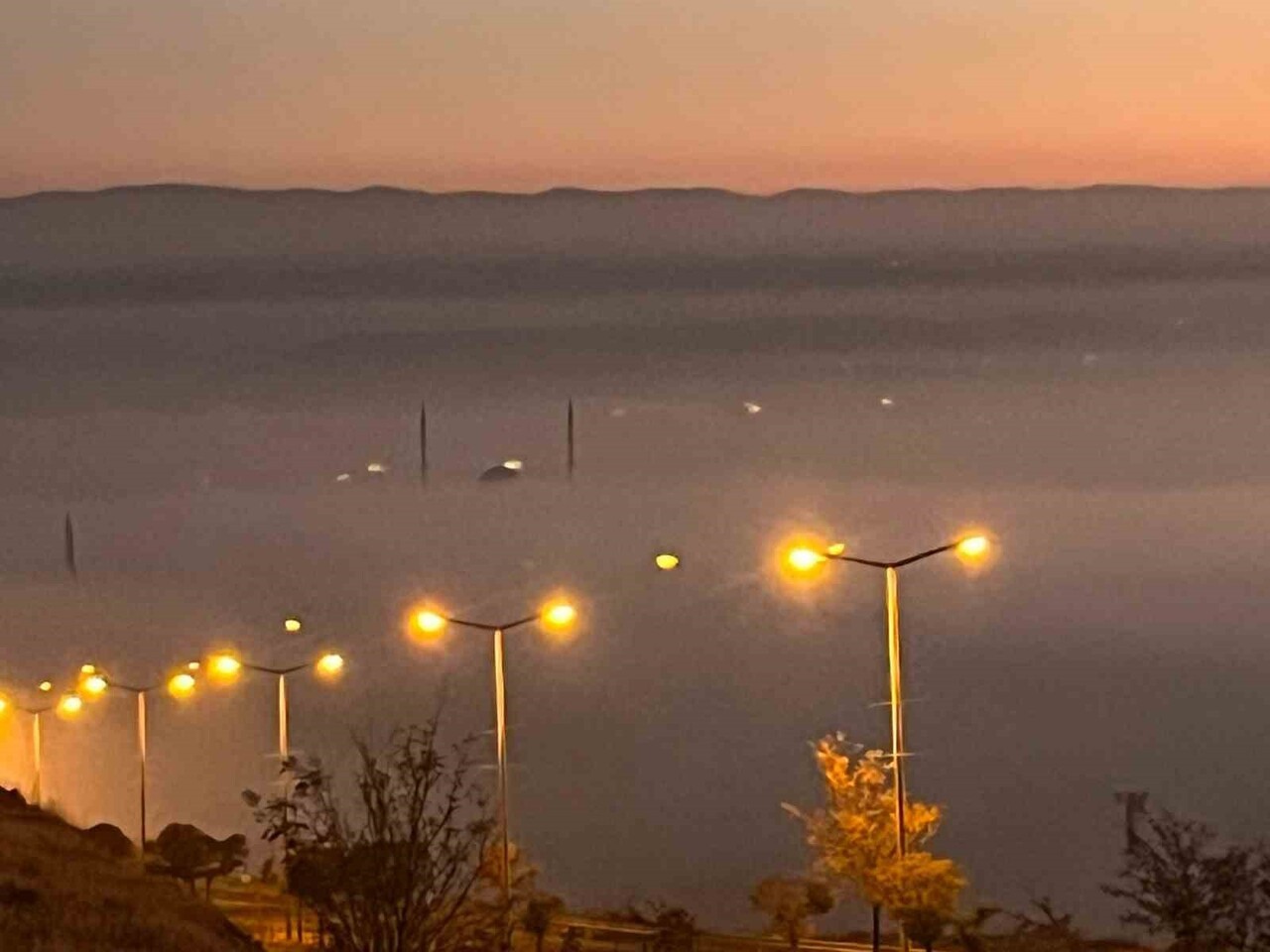 BATMAN’DA AKŞAM SAATLERİNDE ETKİLİ OLAN YOĞUN SİS, GÜN BATIMININ KIZILLIĞIYLA BİRLEŞEREK ŞEHRİN...