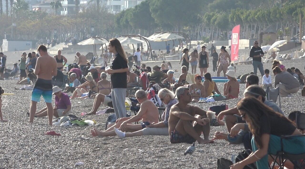 KONYAALTI SAHİLLERİ GÜN BOYU YOĞUNLUK YAŞARKEN, FALEZLERDEN DENİZE ATLAYAN VATANDAŞLAR, KANO İLE...